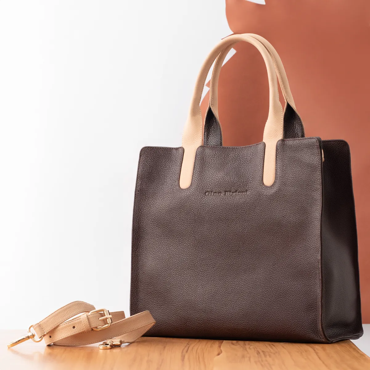 Brown leather tote with tan handles and shoulder strap